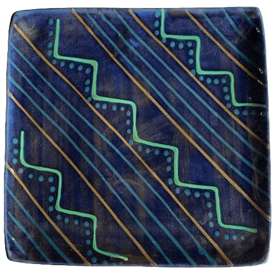 Square pottery design featuring blue background with zigs diagonally.