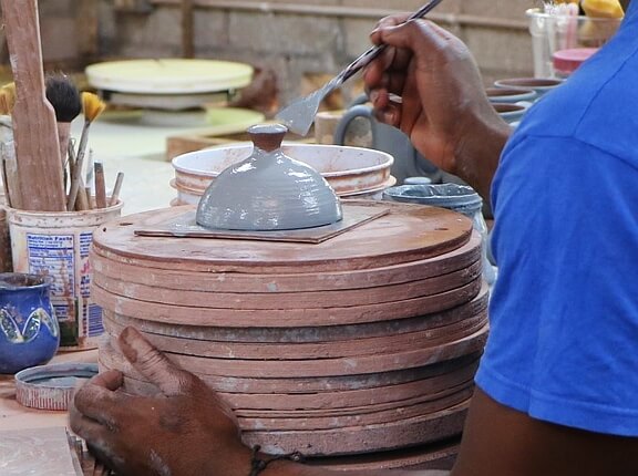 Hand painting ceramics at Earthworks Pottery in Barbados